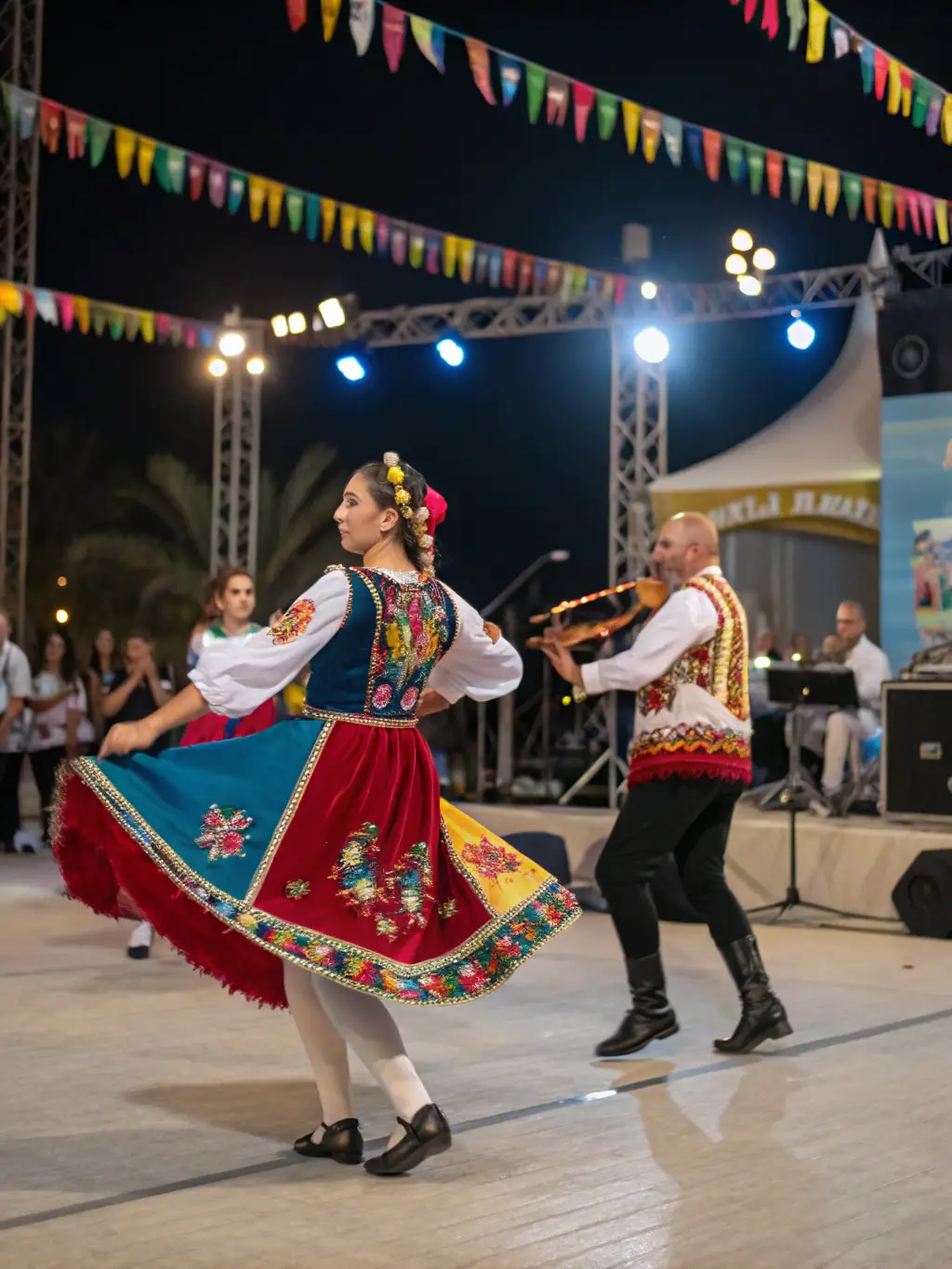 A colorful image of a folk dance festival, with dancers in traditional costumes performing regional dances to live music.